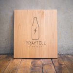 Etched wood sign for Praytell Strategy