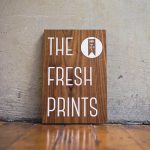 The Fresh Prints walnut sign