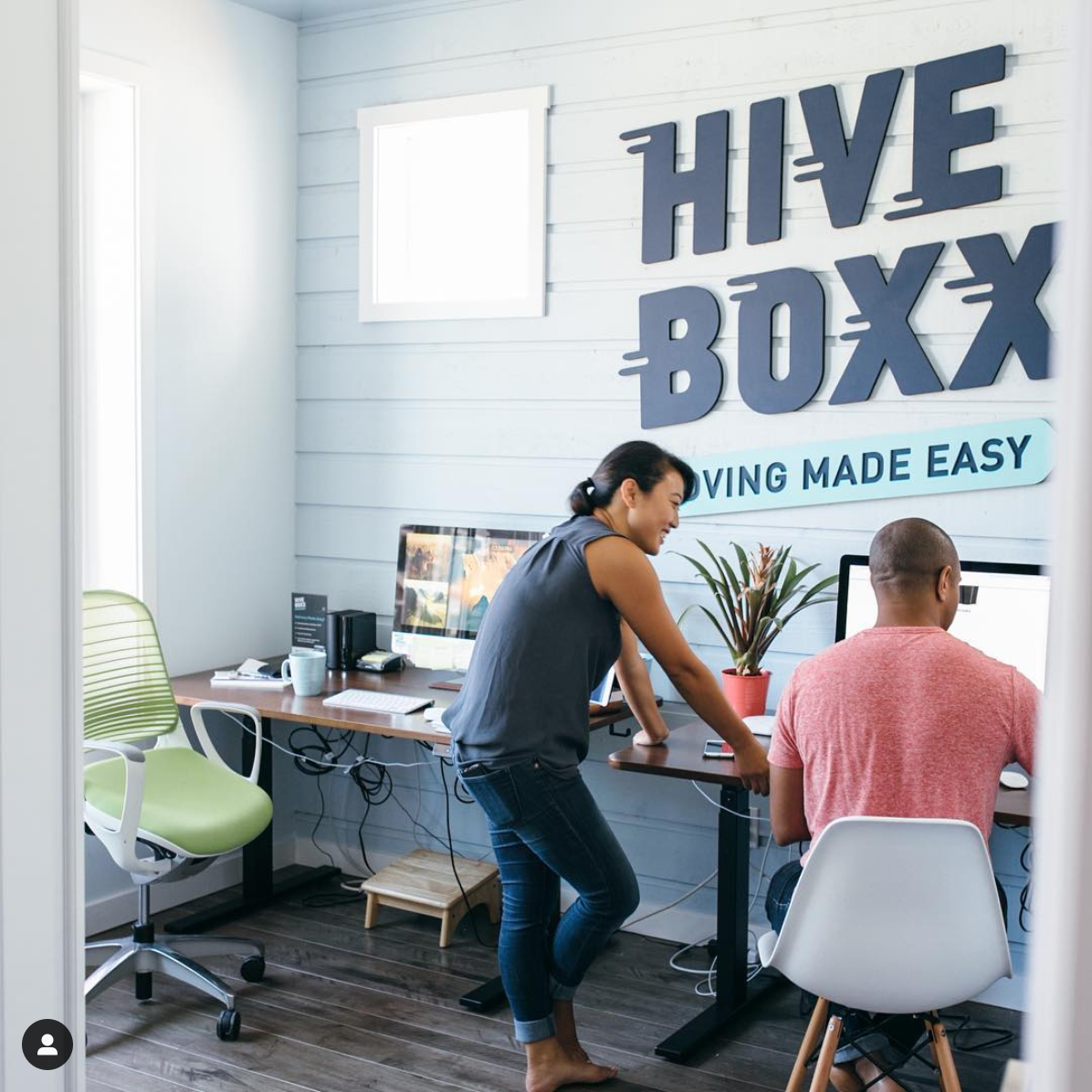 Matte blue sign for HiveBoxx, a moving box rental company in Seattle, WA
