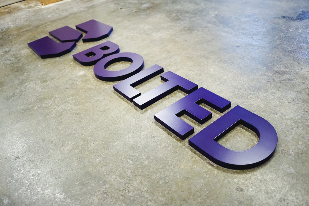 Bolted purple wall sign