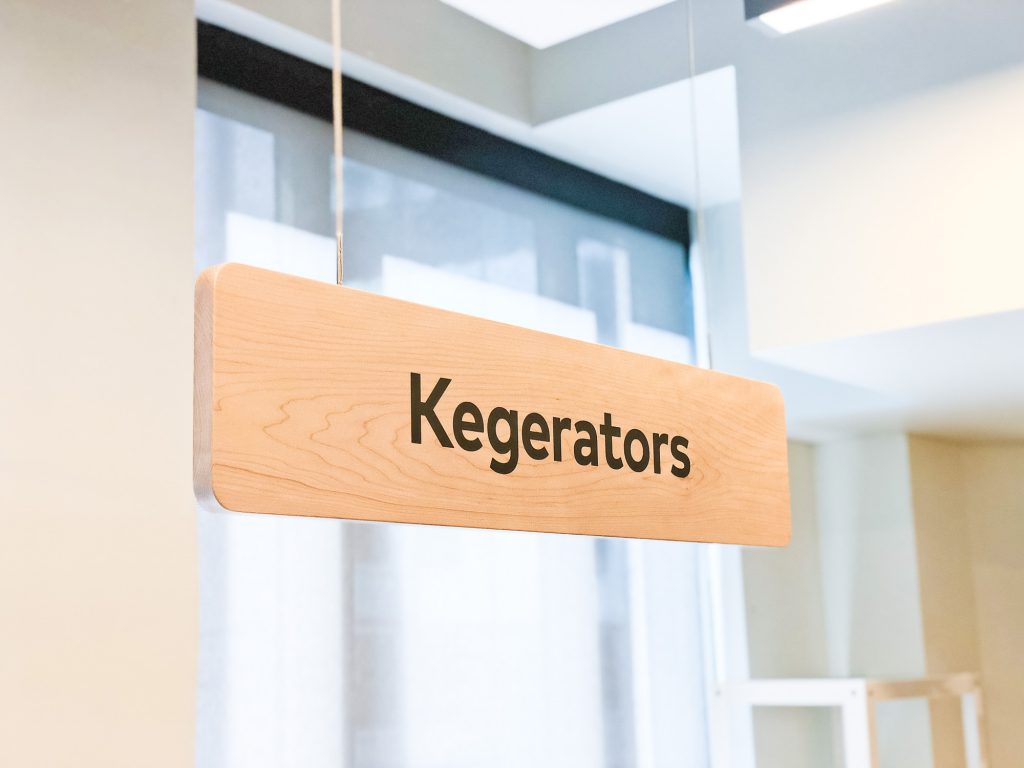 Suspended wood signage for the cafeteria of Thumbtack, an online service that matches customers with local professionals.