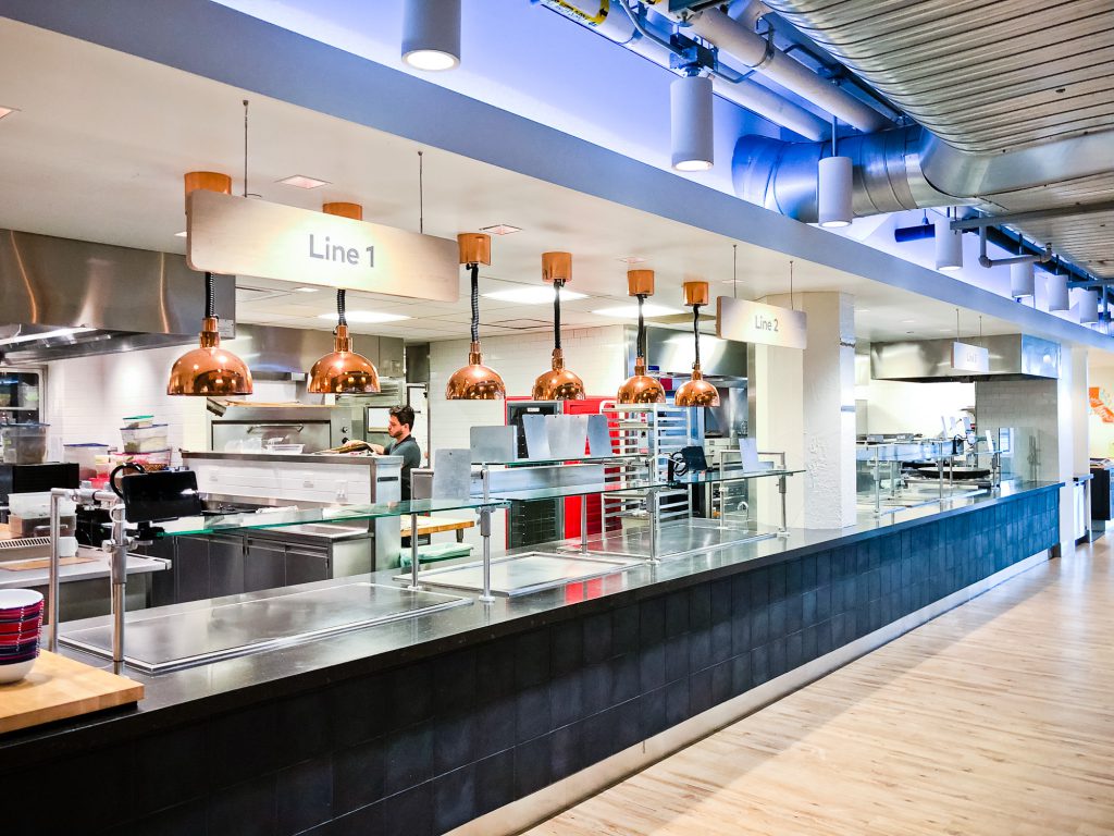 Suspended wood signage for the cafeteria of Thumbtack, an online service that matches customers with local professionals.