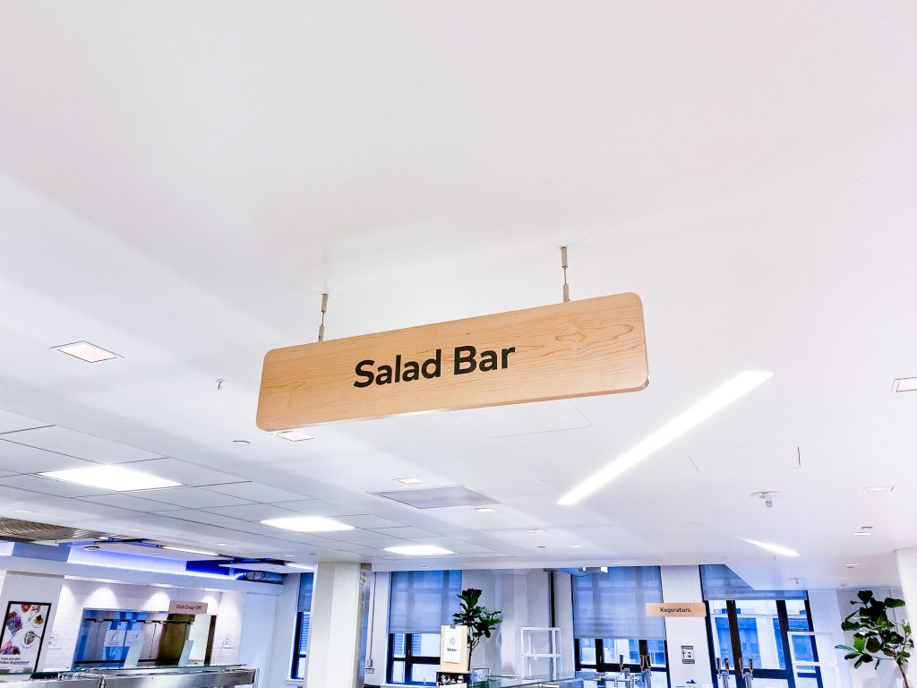 Suspended wood signage for the cafeteria of Thumbtack, an online service that matches customers with local professionals.