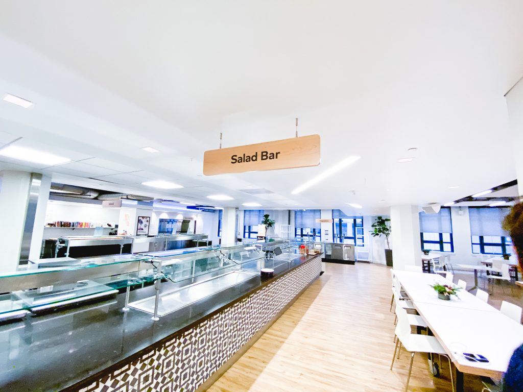 Suspended wood signage for the cafeteria of Thumbtack, an online service that matches customers with local professionals.