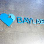 Baylabs blue logo lobby floating wall sign