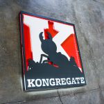 Illuminated propaganda style sign in red, white, and black sign for Kongregate, a gaming company.