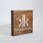 One of many solid walnut freestanding tabletop retail sign with artwork in white ink for Krimson Klover, a clothing company.