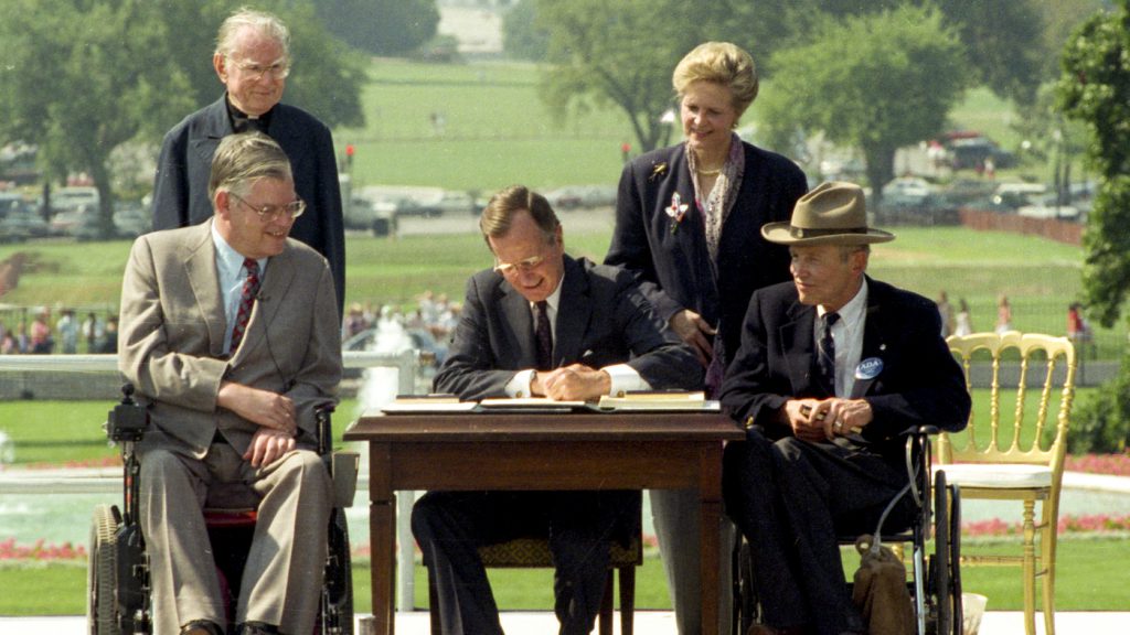 President George H.W. Bush signed the Americans with Disabilities Act on the South Lawn of the White House on July 26, 1990. "Let the shameful wall of exclusion finally come tumbling down," he said that day.