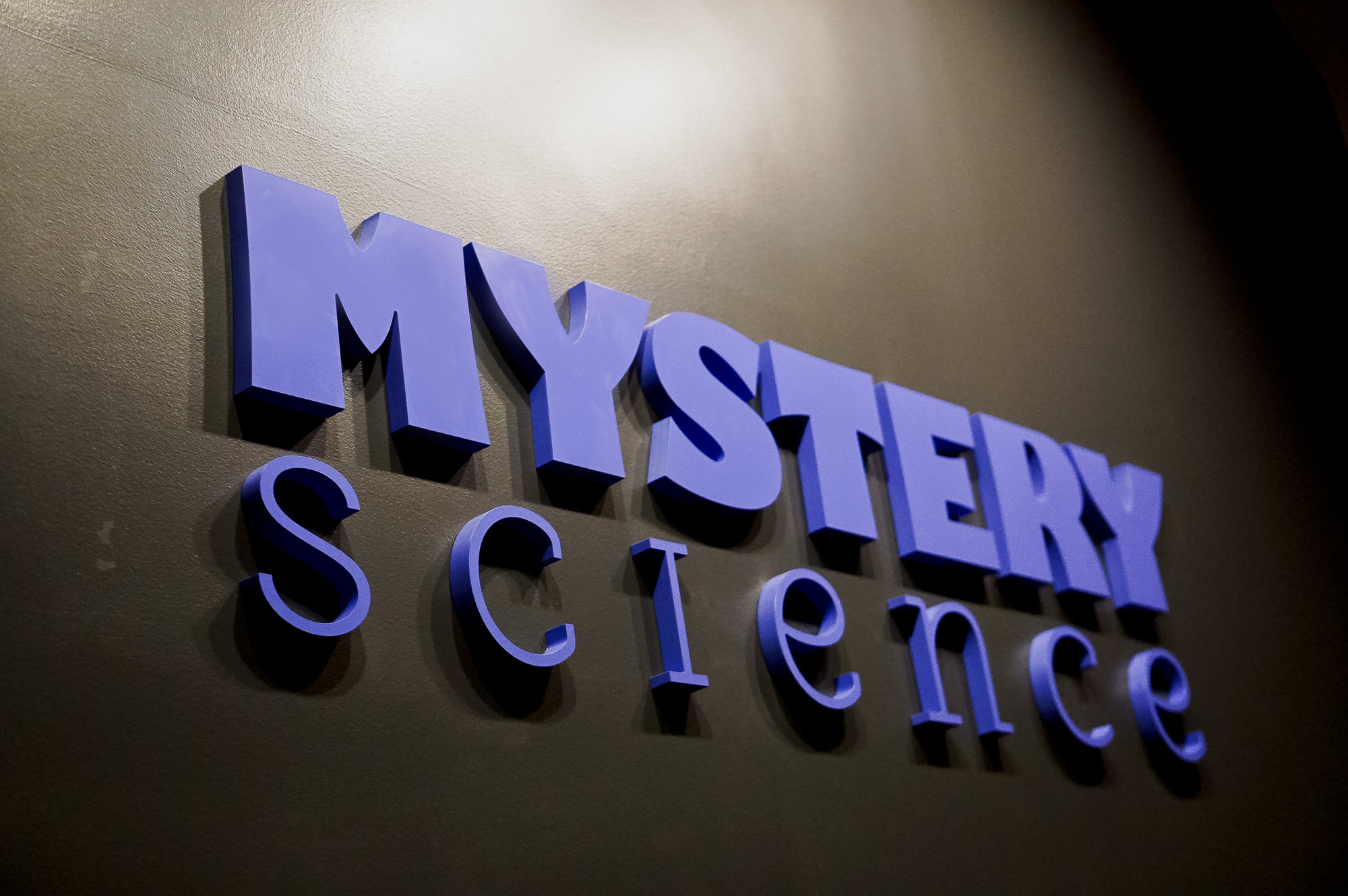 Purple letters on dark grey wall for the Knotel designed Mystery Science lobby, a company that provides open-and-go lessons that inspire kids to love science. Purple letters on dark grey wall for the Knotel designed Mystery Science lobby, a company that provides open-and-go lessons that inspire kids to love science.