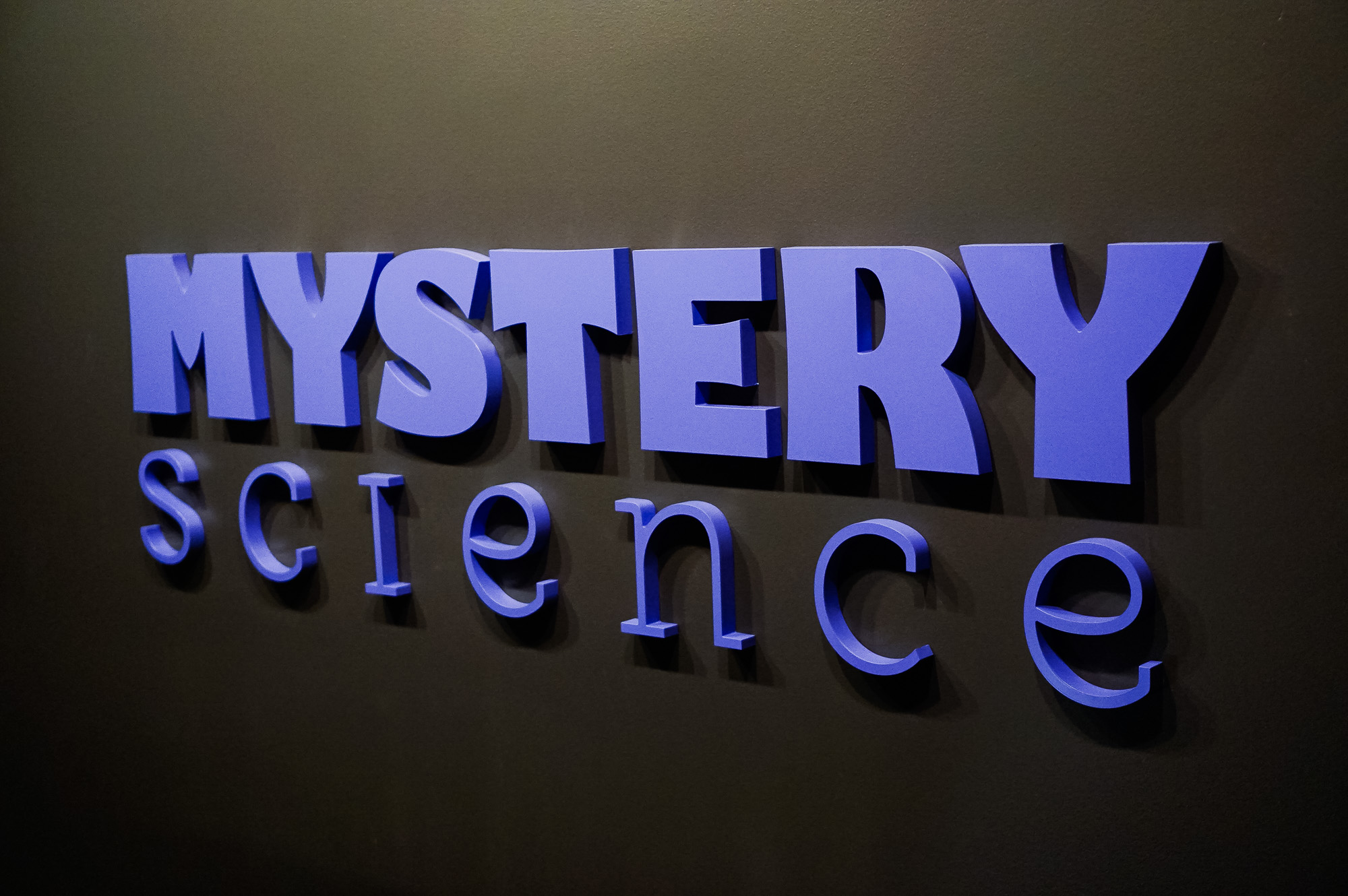 Purple letters on dark grey wall for the Knotel designed Mystery Science lobby, a company that provides open-and-go lessons that inspire kids to love science. Purple letters on dark grey wall for the Knotel designed Mystery Science lobby, a company that provides open-and-go lessons that inspire kids to love science.