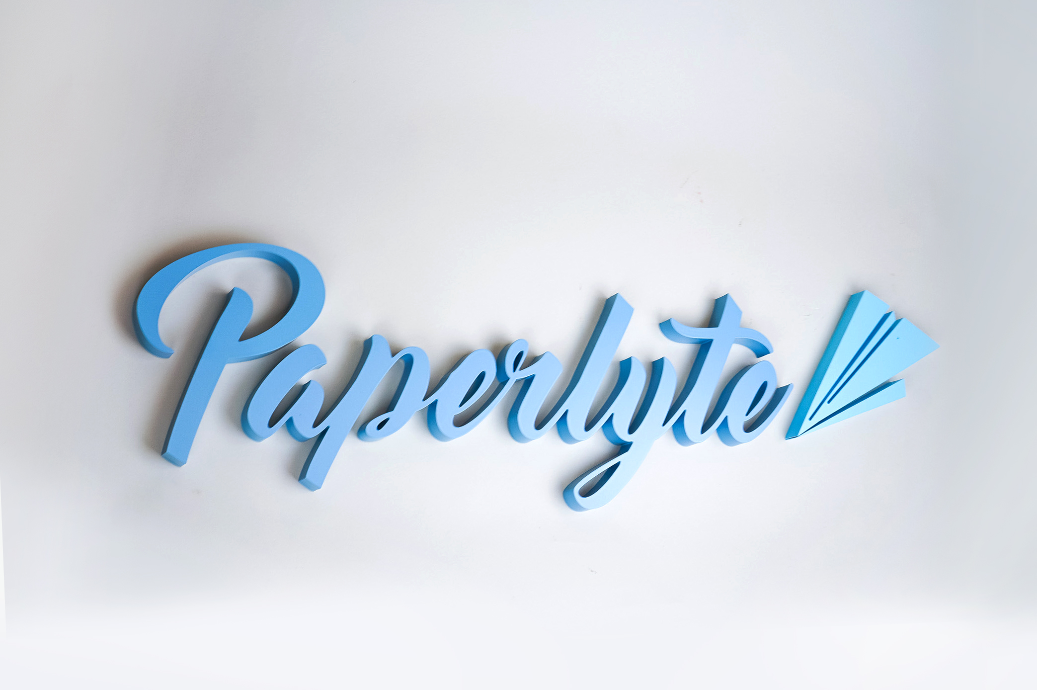Blue dimensional script sign for Paperlyte, a media production company specializing in live streaming, video, documentary, and commercial content. Blue dimensional script sign for Paperlyte, a media production company specializing in live streaming, video, documentary, and commercial content.