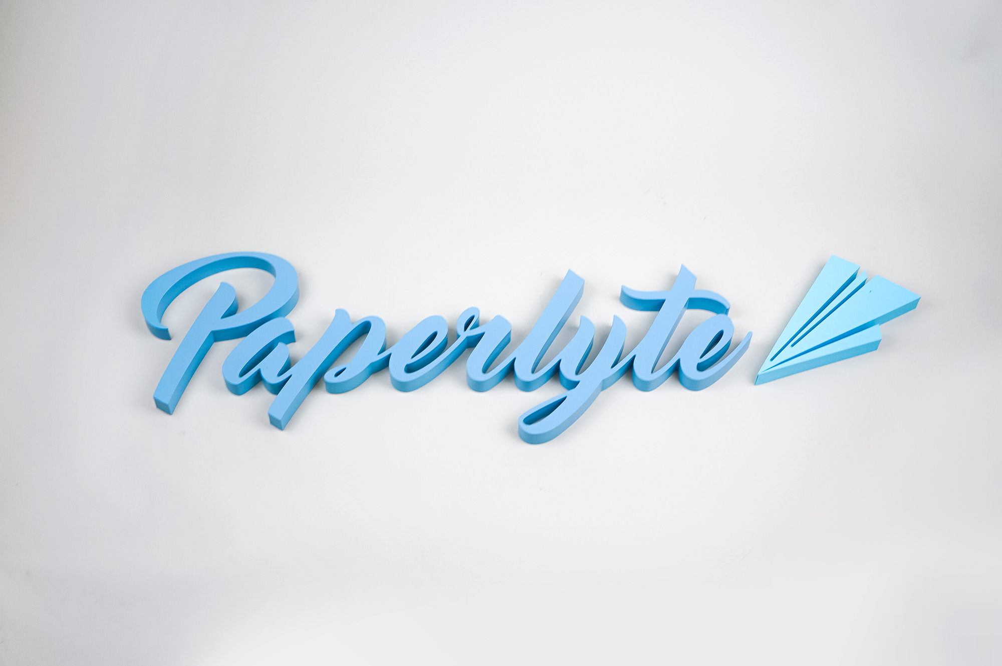 Blue dimensional script sign for Paperlyte, a media production company specializing in live streaming, video, documentary, and commercial content. Blue dimensional script sign for Paperlyte, a media production company specializing in live streaming, video, documentary, and commercial content.