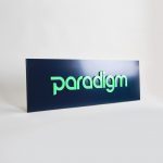 Green and navy, modern, raised text panel sign for Paradigm, a tech company currently located at WeWork in Oakland, CA.