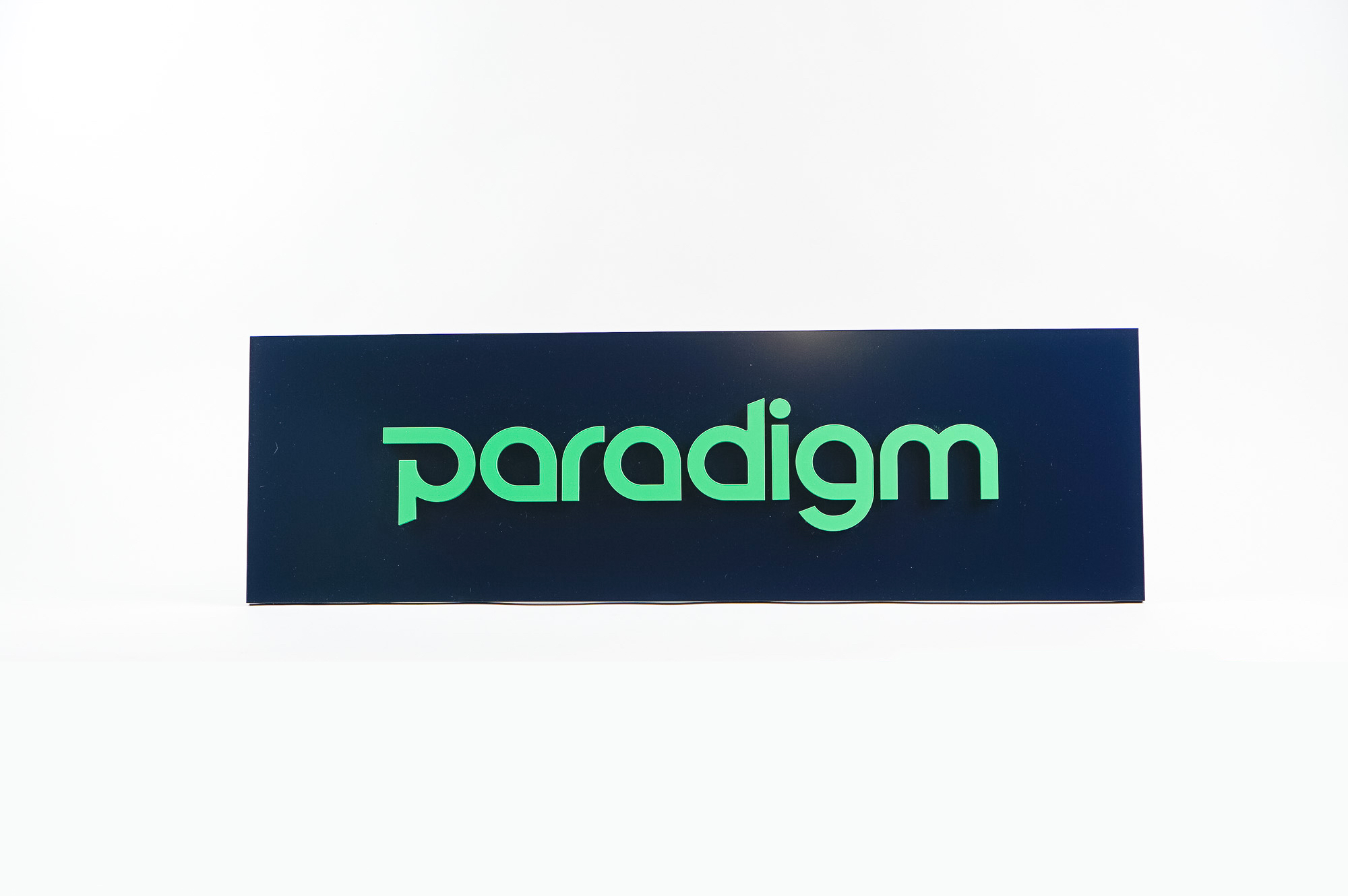 Green and navy, modern, raised text panel sign for Paradigm, a tech company currently located at WeWork in Oakland, CA.