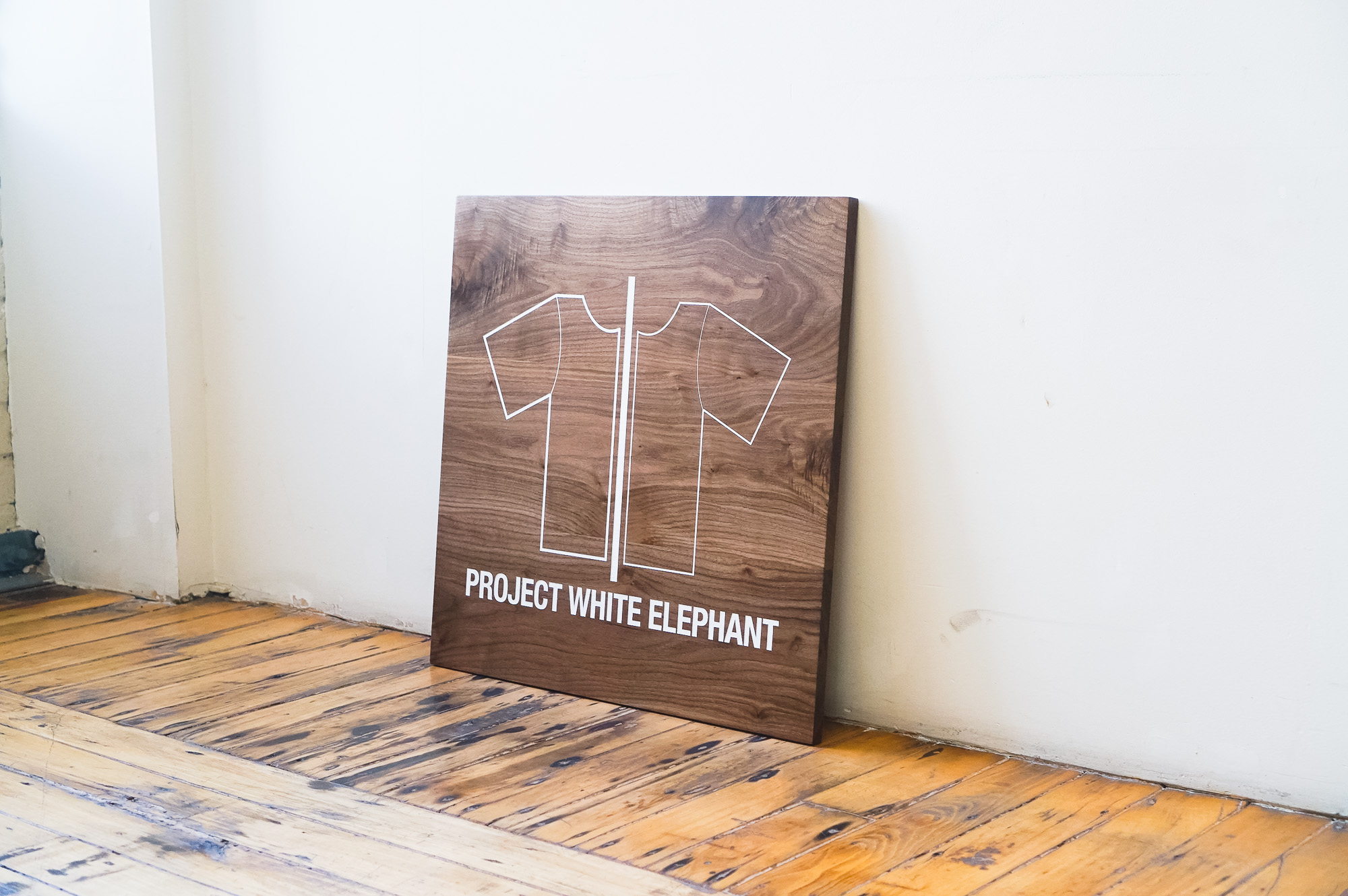 Solid walnut sign with white artwork for Project White Elephant, a womenswear brand based in San Francisco, California. Solid walnut sign with white artwork for Project White Elephant, a womenswear brand based in San Francisco, California.