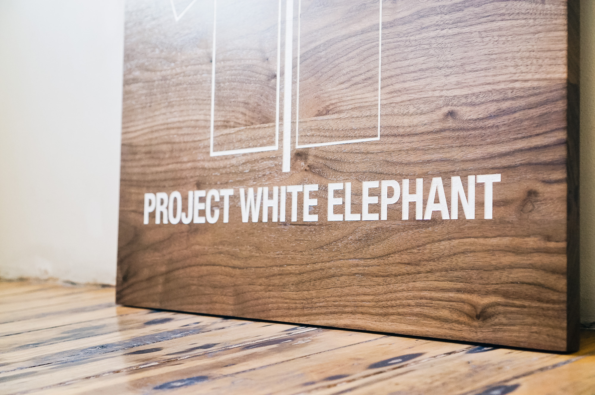 Solid walnut sign with white artwork for Project White Elephant, a womenswear brand based in San Francisco, California. Solid walnut sign with white artwork for Project White Elephant, a womenswear brand based in San Francisco, California.