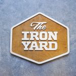 Raised two-toned wood sign for The Iron Yard, a 12-week coding school offered in multiple cities across the US and in London.