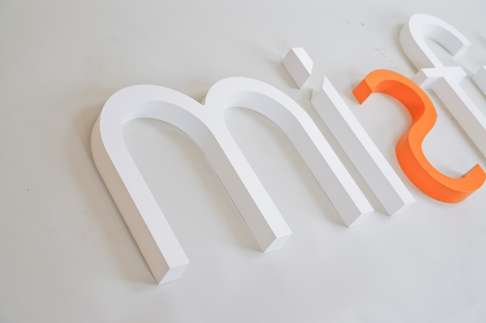 White and orange letter sign for Misfit, a strategic marketing agency. White and orange letter sign for Misfit, a strategic marketing agency.