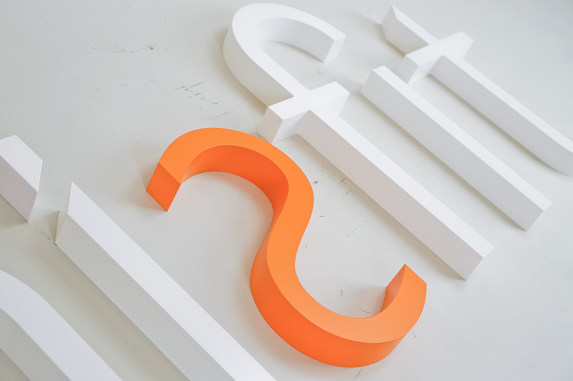 White and orange letter sign for Misfit, a strategic marketing agency.