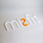 White and orange letter sign for Misfit, a strategic marketing agency.
