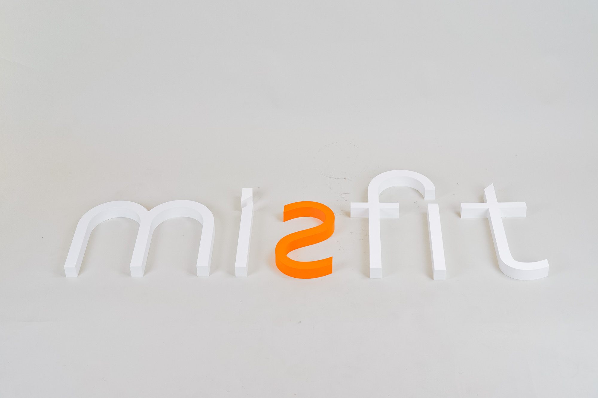 White and orange letter sign for Misfit, a strategic marketing agency. White and orange letter sign for Misfit, a strategic marketing agency.