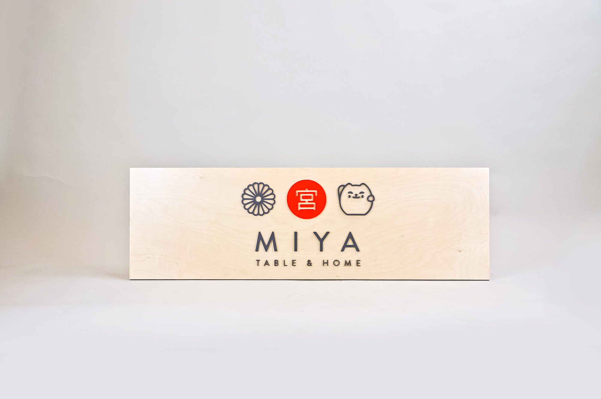 Raised black, red, and light wood sign with icons for Miya Table & Home, a third-generation family owned business, importing Japanese tableware and gifts since 1947. Raised black, red, and light wood sign with icons for Miya Table & Home, a third-generation family owned business, importing Japanese tableware and gifts since 1947.