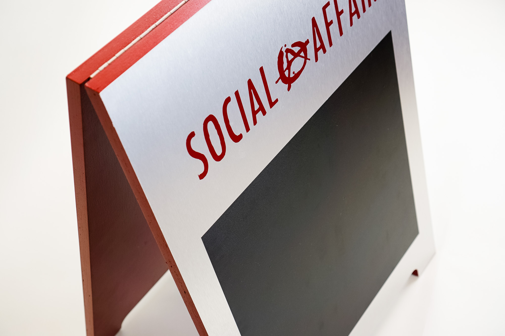 Metal and red A-frame sign for Social Affair, a restaurant serving artisanal food, wine and chai in a casual and modern lounge