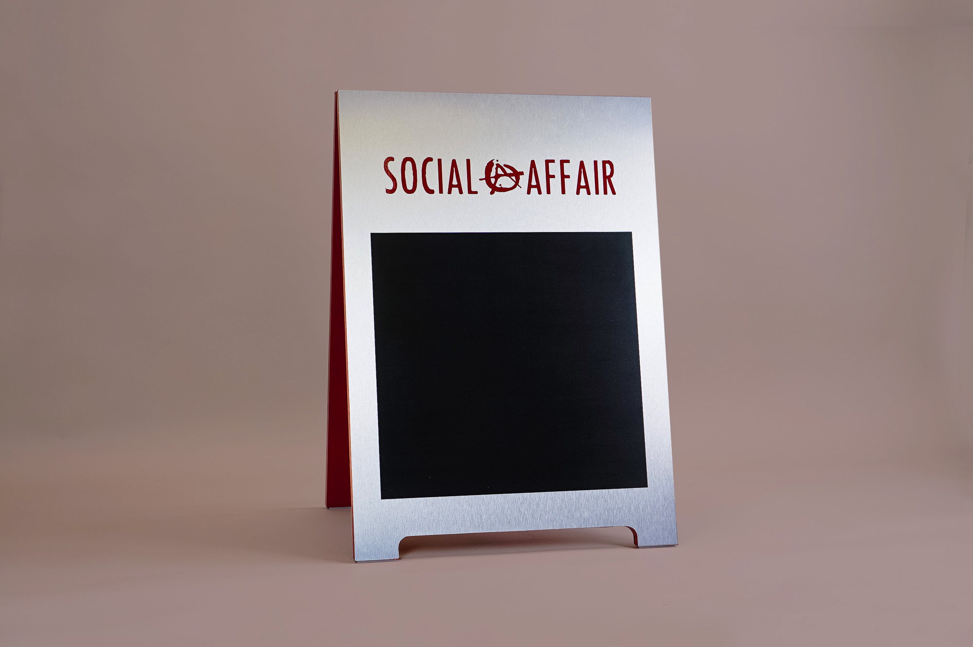 Metal and red A-frame sign for Social Affair, a restaurant serving artisanal food, wine and chai in a casual and modern lounge