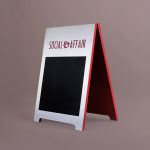 Metal and red A-frame sign for Social Affair, a restaurant serving artisanal food, wine and chai in a casual and modern lounge