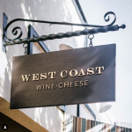 Outdoor hanging sign for West Coast Wine and Cheese, a San Francisco based bar and gastropub.