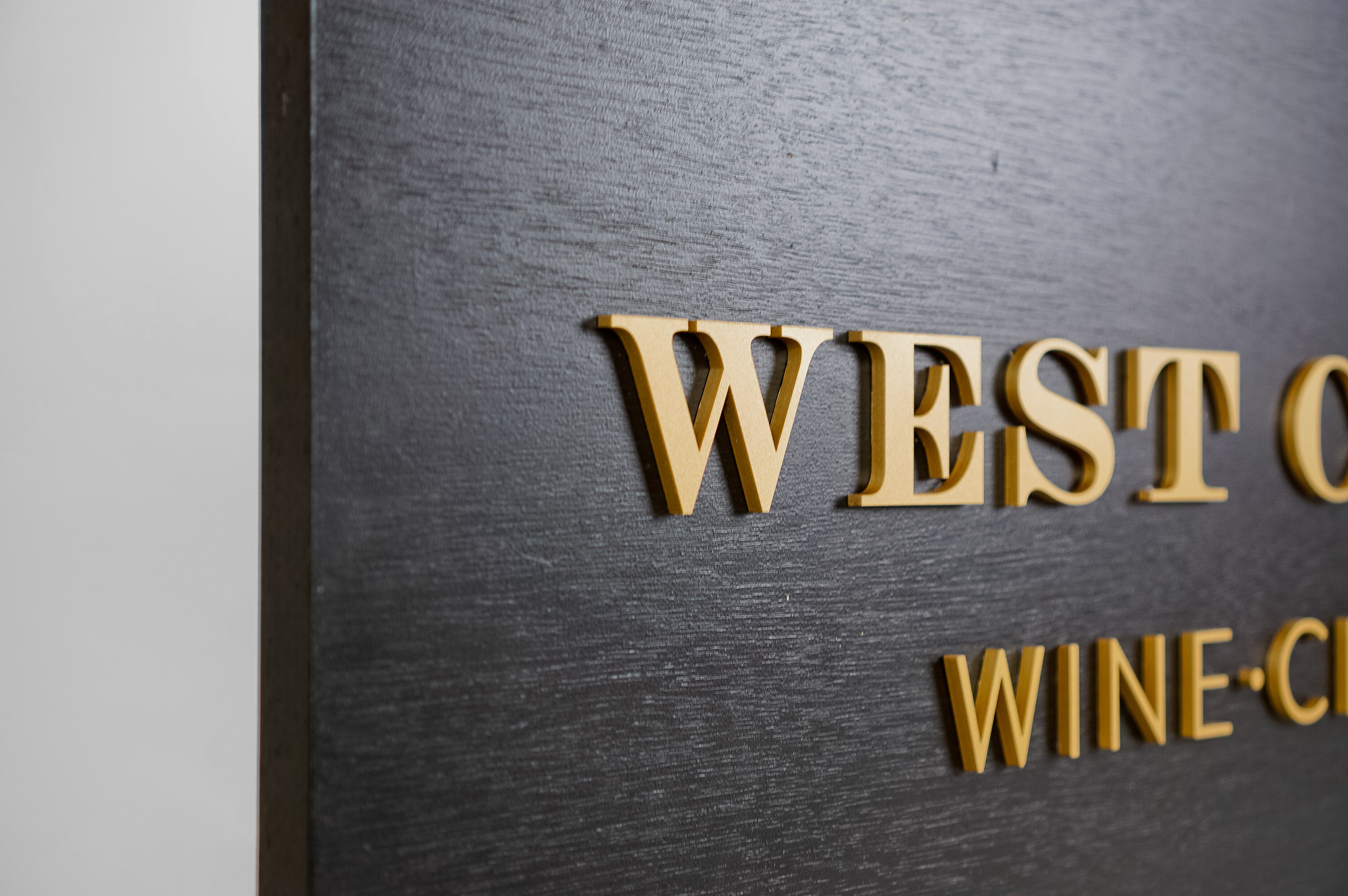 Outdoor hanging sign for West Coast Wine and Cheese, a San Francisco based bar and gastropub. Outdoor hanging sign for West Coast Wine and Cheese, a San Francisco based bar and gastropub.