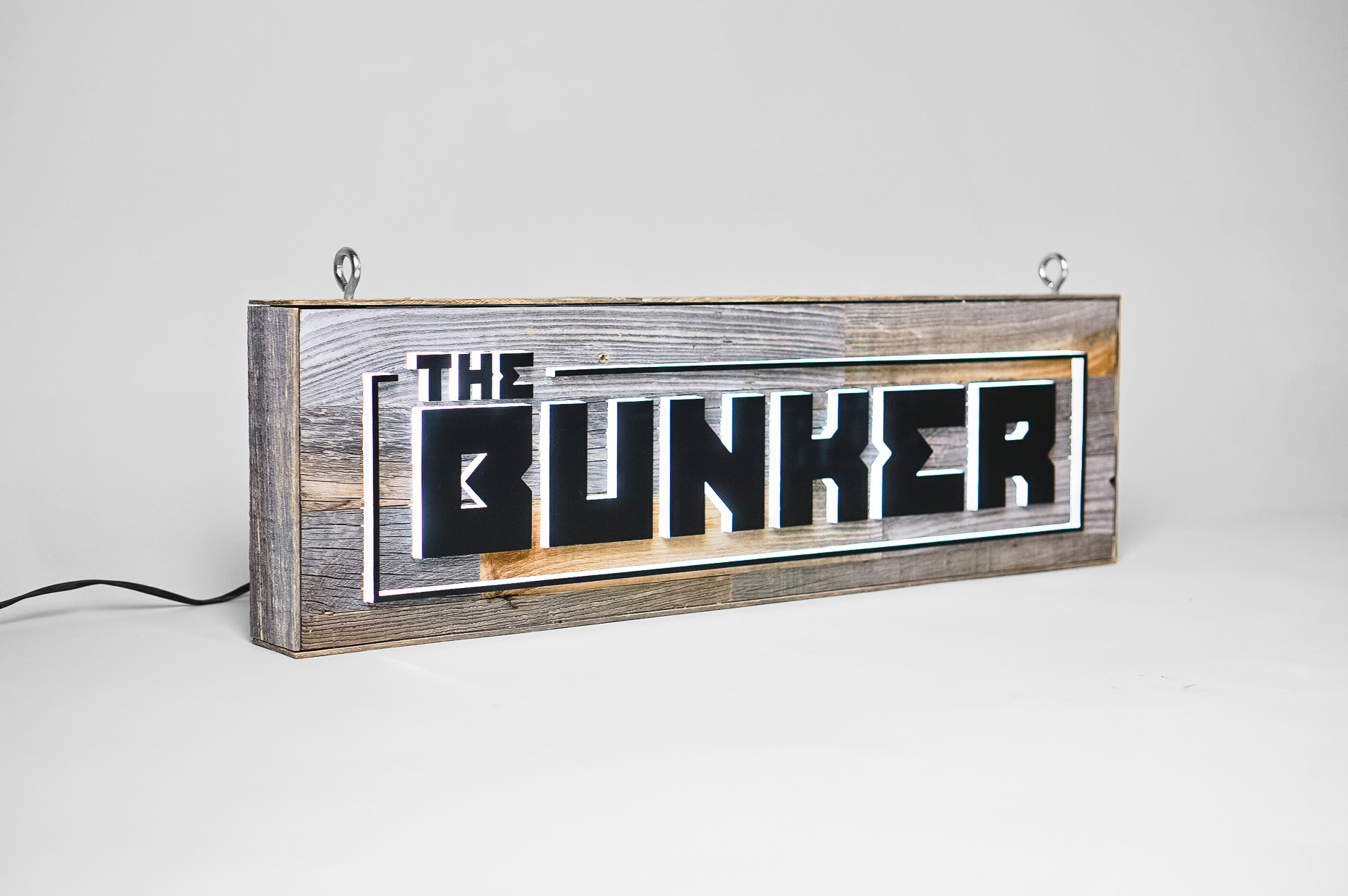 Illuminated, reclaimed wood sign for The Bunker, a comedy club in Burbank, CA. Illuminated, reclaimed wood sign for The Bunker, a comedy club in Burbank, CA.