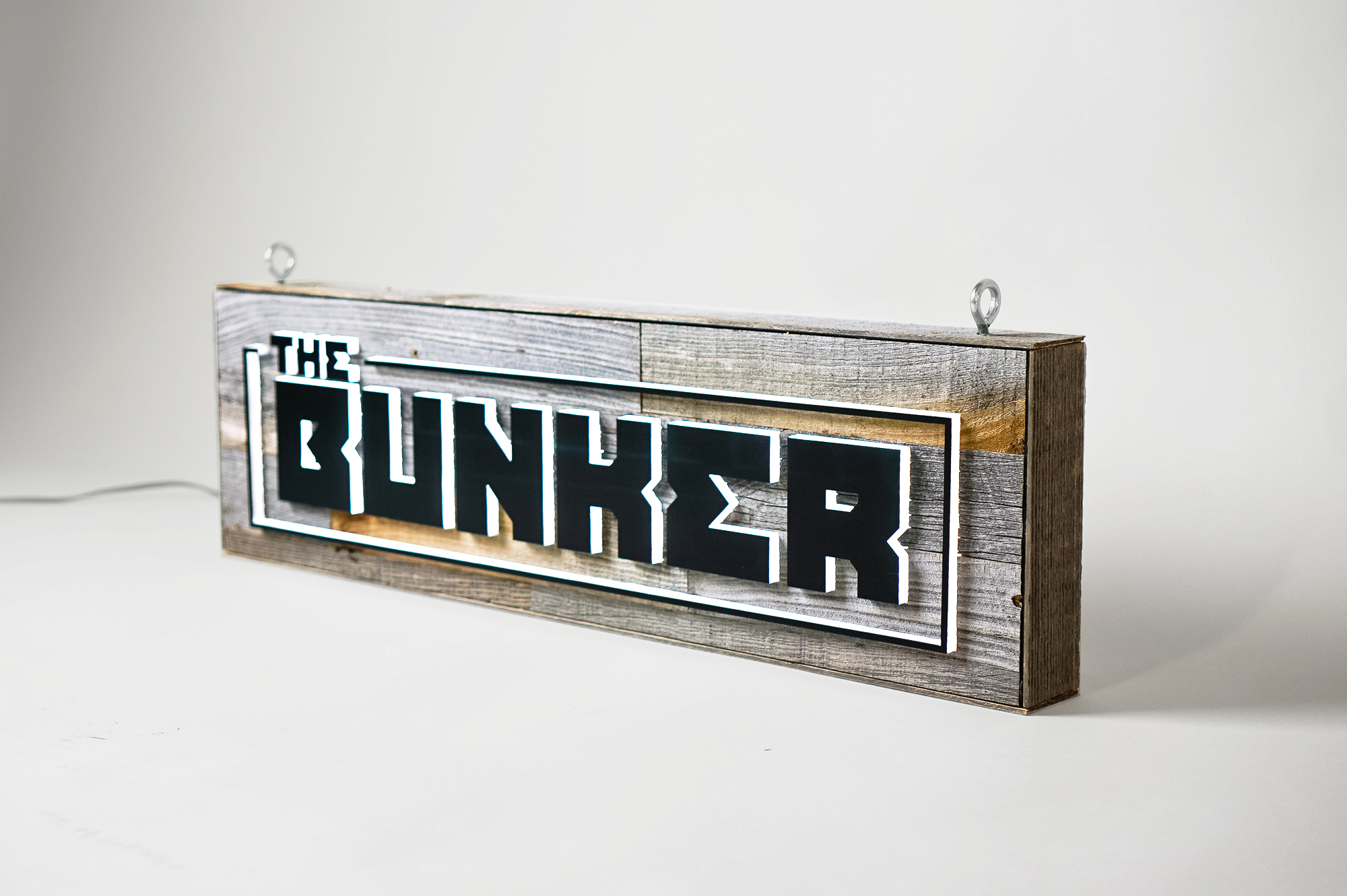 Illuminated, reclaimed wood sign for The Bunker, a comedy club in Burbank, CA.
