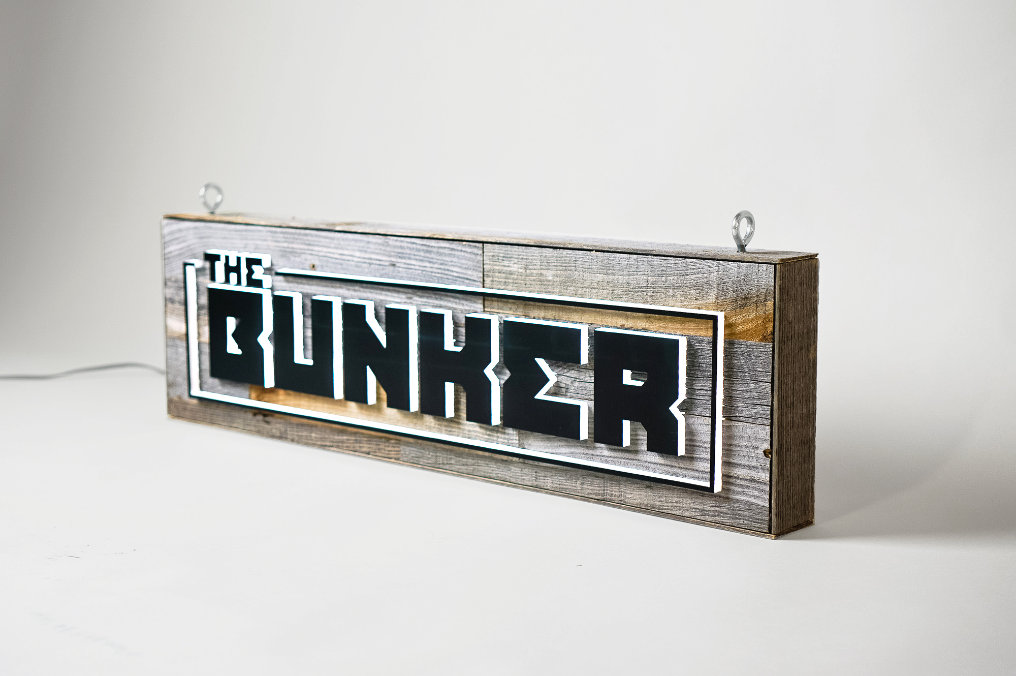Illuminated, reclaimed wood sign for The Bunker, a comedy club in Burbank, CA. Illuminated, reclaimed wood sign for The Bunker, a comedy club in Burbank, CA.