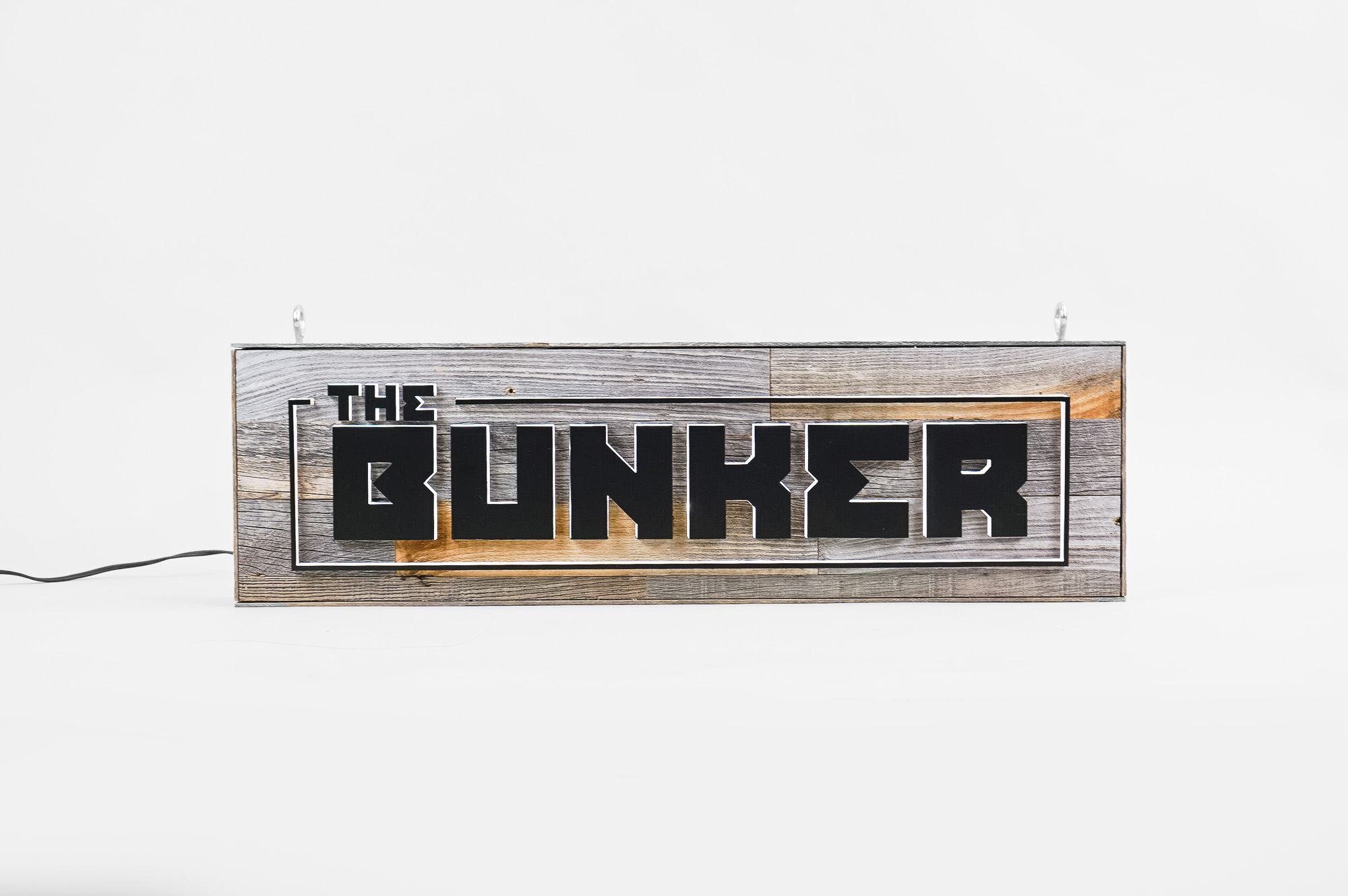 Illuminated, reclaimed wood sign for The Bunker, a comedy club in Burbank, CA. Illuminated, reclaimed wood sign for The Bunker, a comedy club in Burbank, CA.