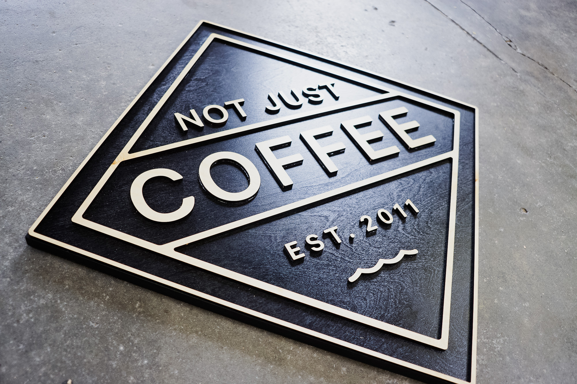 Black and light wood sign for Not Just Coffee Black and light wood sign for Not Just Coffee