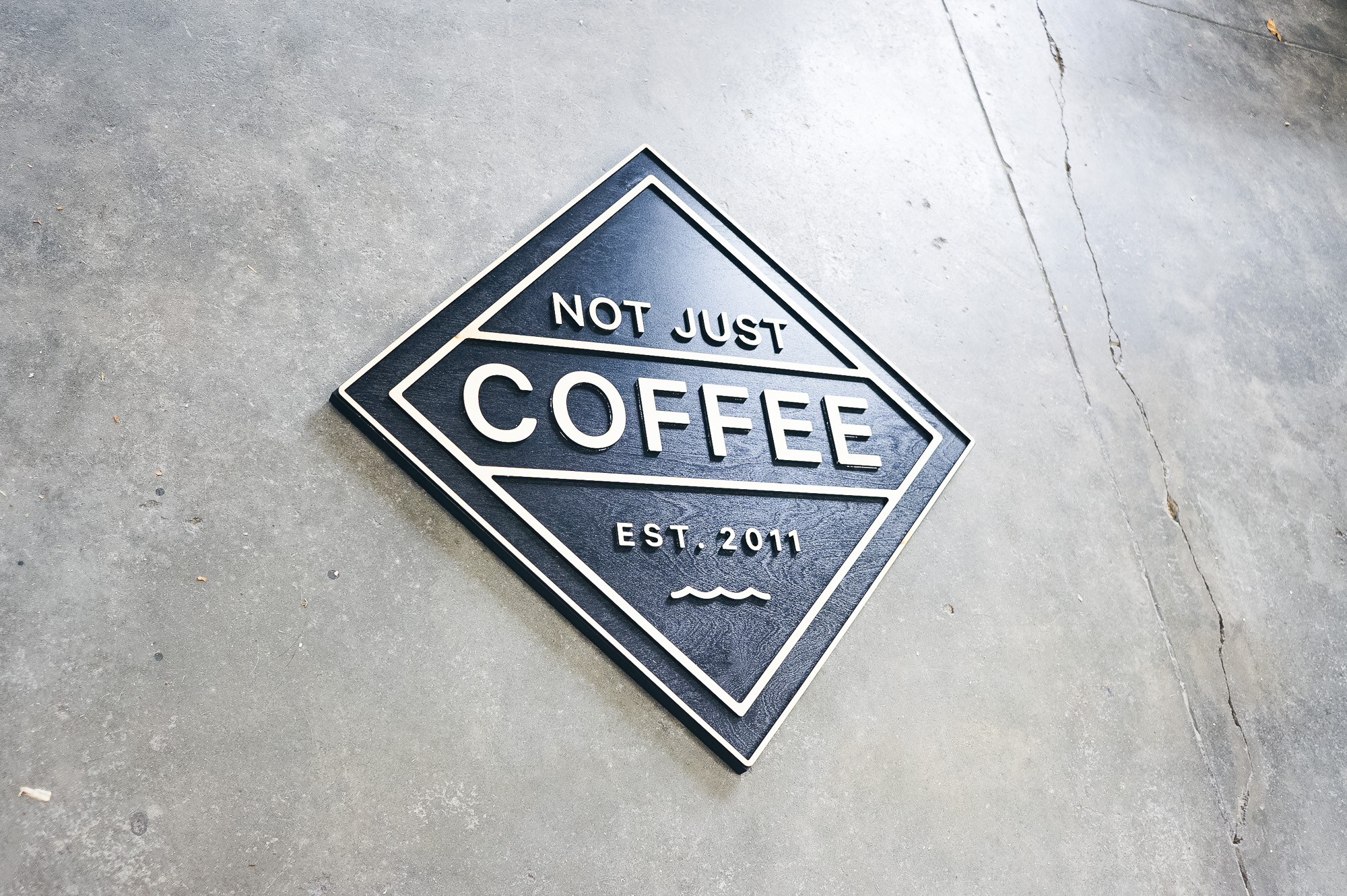 Black and light wood sign for Not Just Coffee Black and light wood sign for Not Just Coffee
