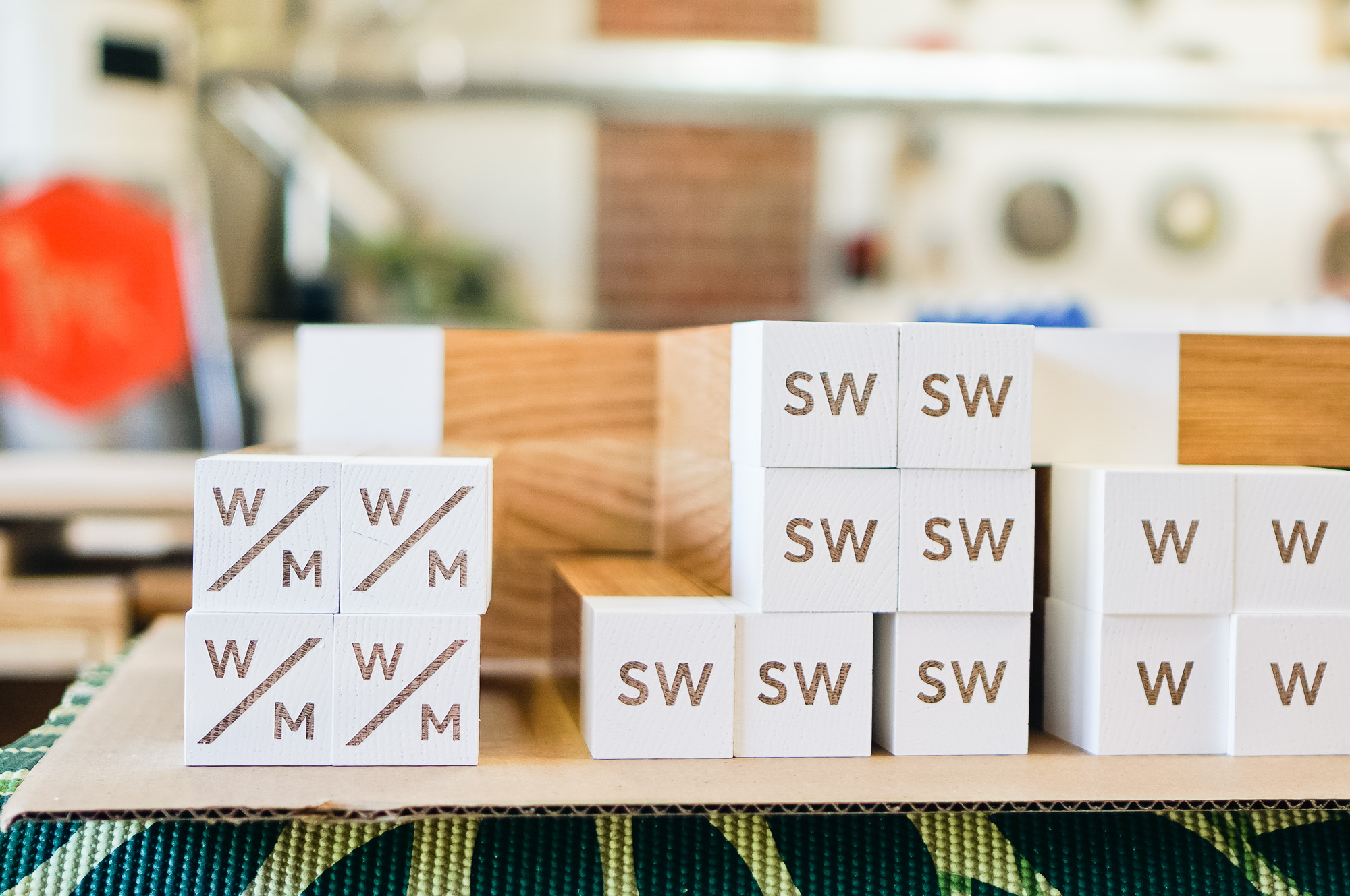 White-painted wood, national park-inspired, overhead wayfinding sign for the office of Slack, a cloud-based set of proprietary team collaboration tools and services.