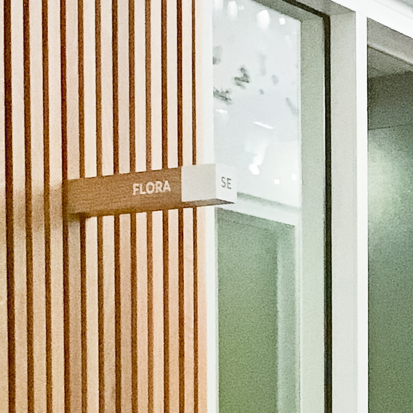 White-painted wood, national park-inspired, overhead wayfinding sign for the office of Slack, a cloud-based set of proprietary team collaboration tools and services. White-painted wood, national park-inspired, overhead wayfinding sign for the office of Slack, a cloud-based set of proprietary team collaboration tools and services.
