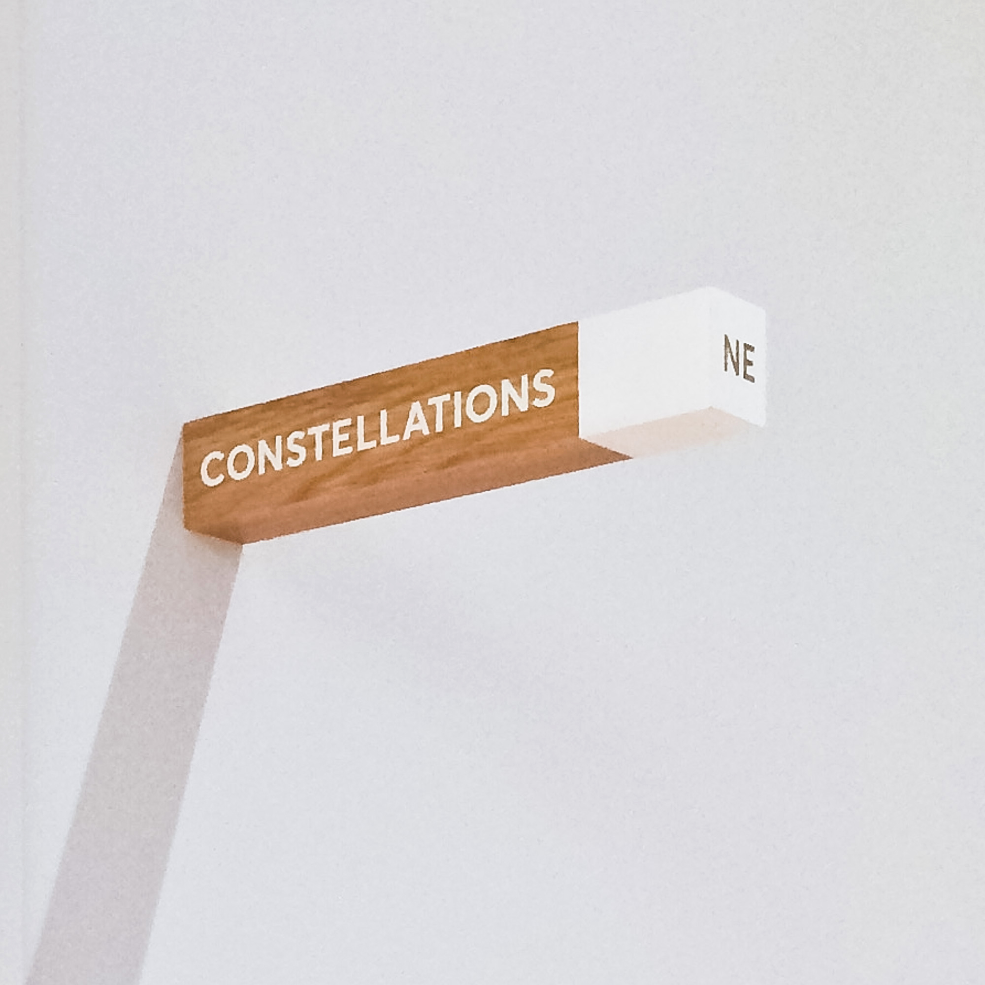 White-painted wood, national park-inspired, overhead wayfinding sign for the office of Slack, a cloud-based set of proprietary team collaboration tools and services.