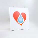 White hanging blade sign with colored logo for B12 LOVE, a San Francisco center offering nutrient therapies.