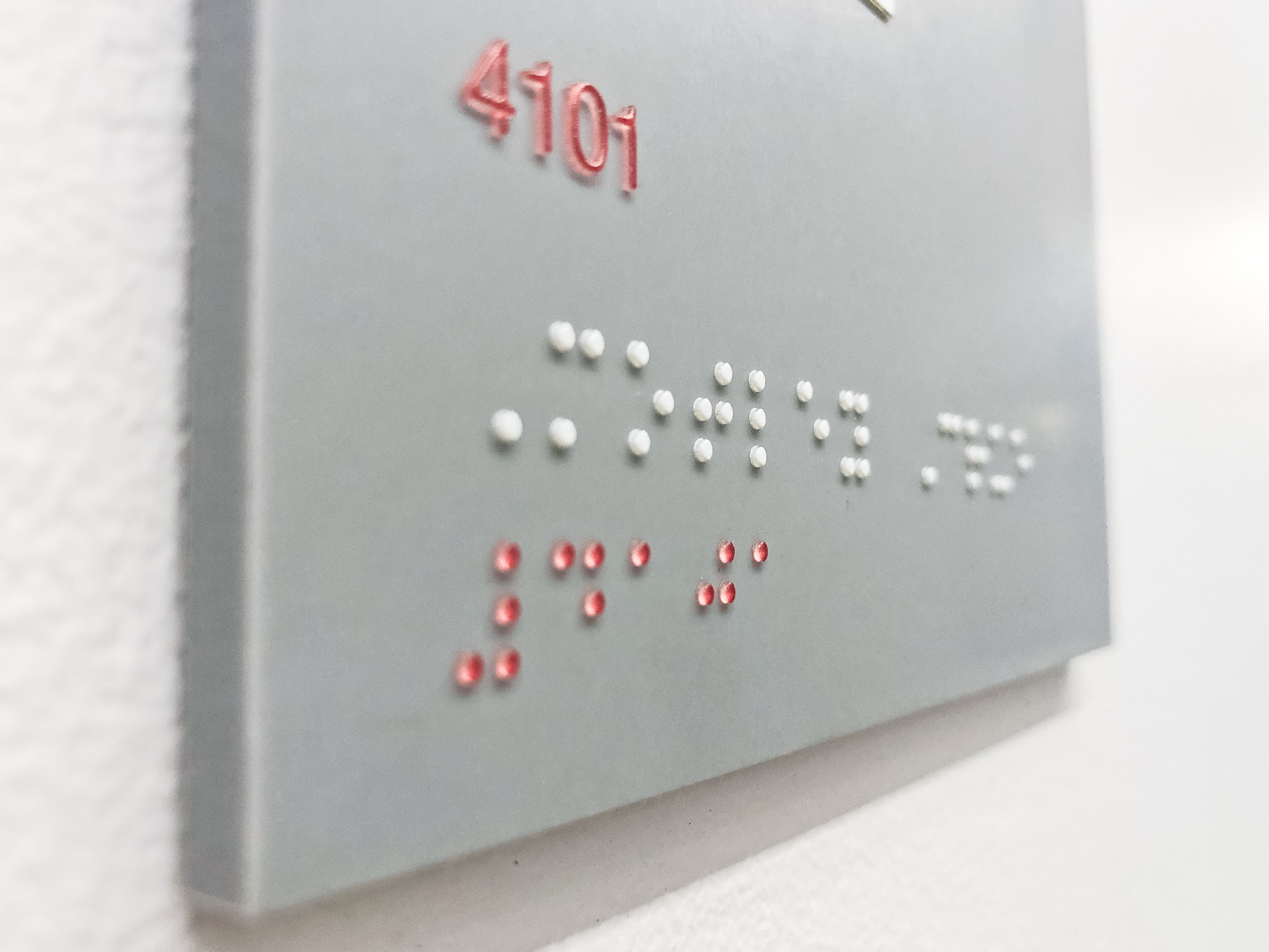 Grey and white meeting room ADA signs with Braille for the San Francisco office of Gong, a conversation intelligence platform for sales.