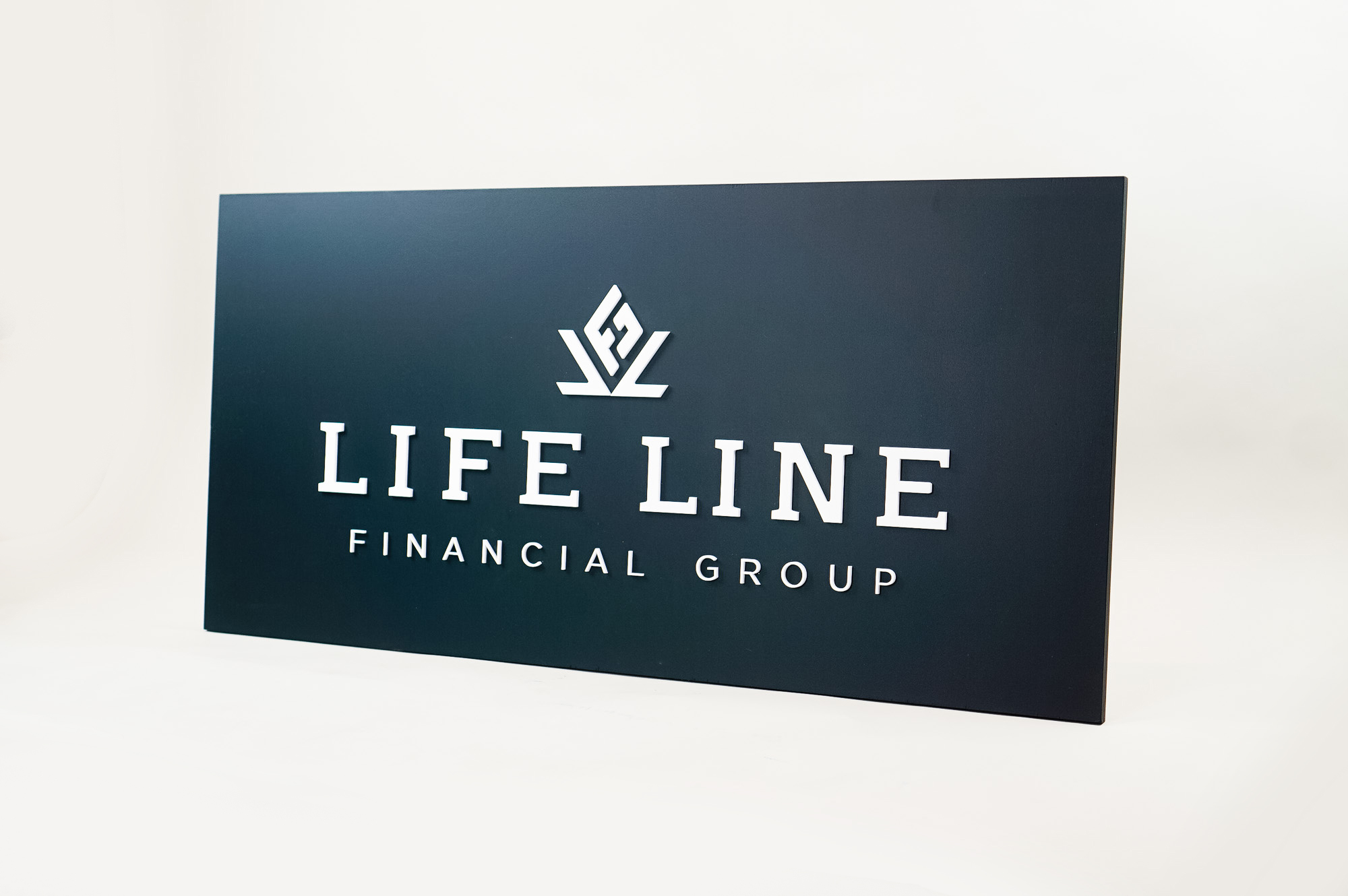 Raised dark navy blue raised sign with white lettering for Life Line Financial Group, a multi-family office with a dedicated team of Certified Financial Planners