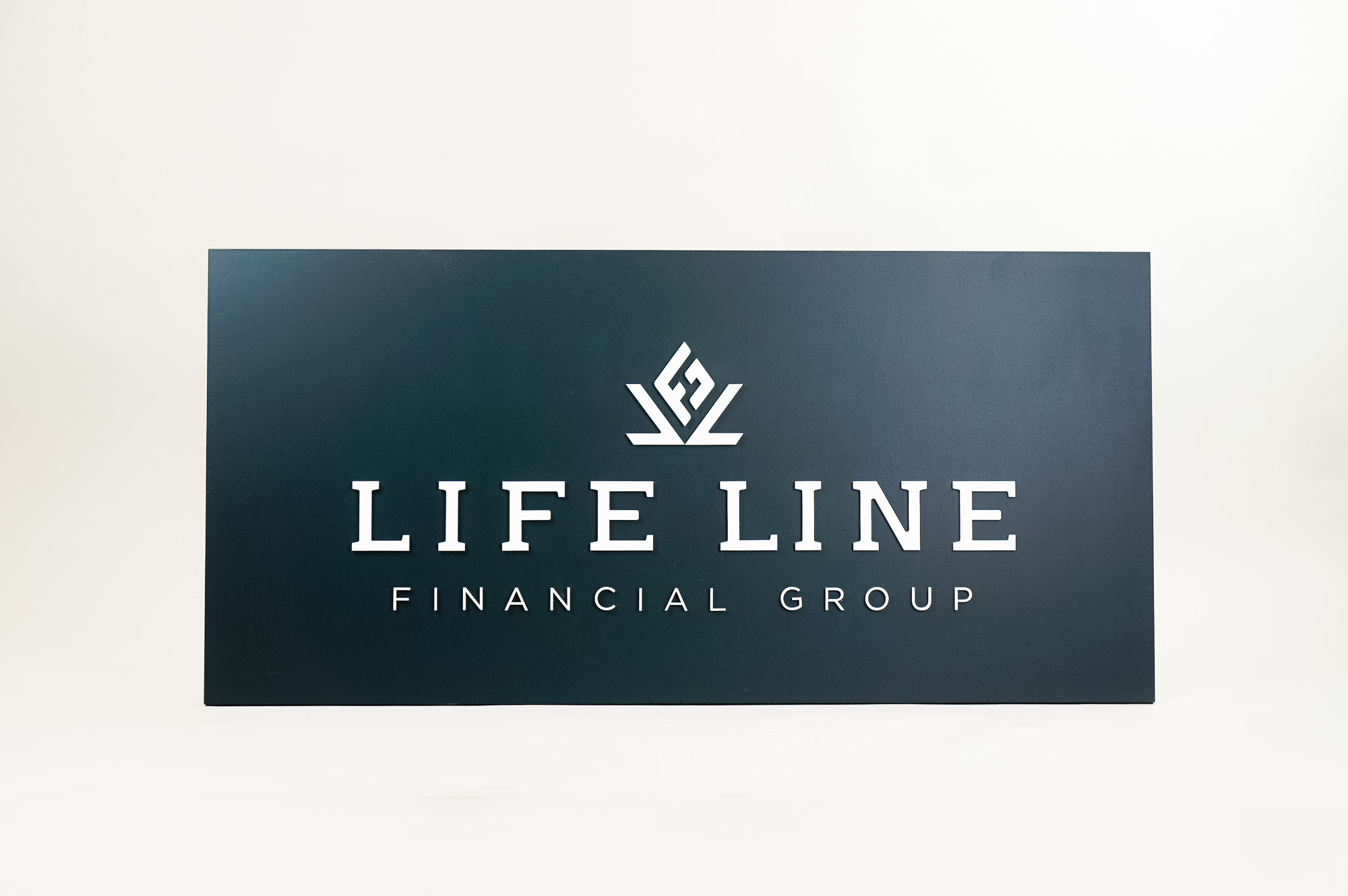 Raised dark navy blue raised sign with white lettering for Life Line Financial Group, a multi-family office with a dedicated team of Certified Financial Planners Raised dark navy blue raised sign with white lettering for Life Line Financial Group, a multi-family office with a dedicated team of Certified Financial Planners