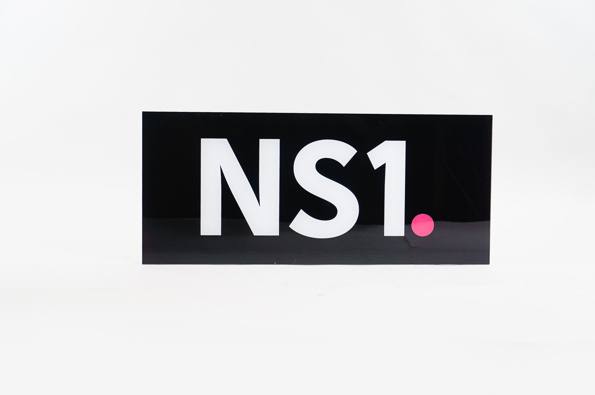 Glossy black, back-painted sign for NS1, a San Francisco based company that manages DNS and traffic technologies.
