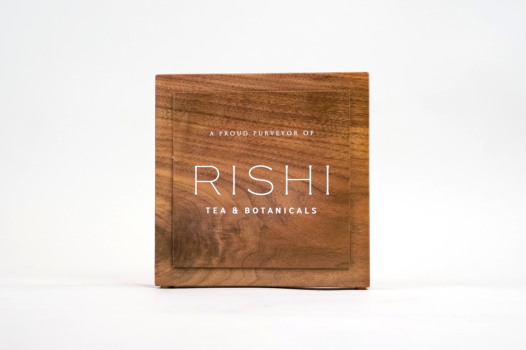 Solid walnut retail/cafe sign with white artwork for RIshi, a Direct Trade importer of organic teas and botanicals from the very best sources.