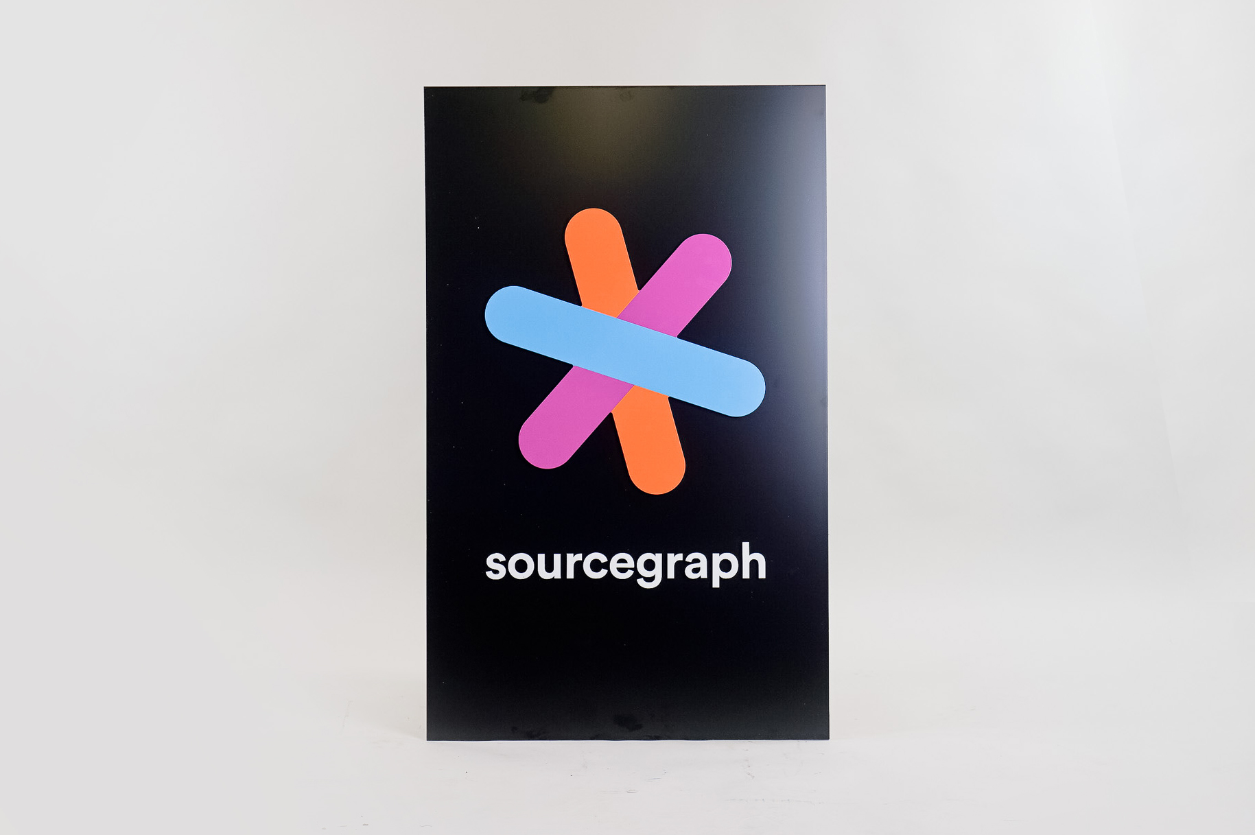 Simple black blade sign with colored logo for Sourcegraph, a San Francisco-based company that adds code intelligence to GitHub and other code hosts. Simple black blade sign with colored logo for Sourcegraph, a San Francisco-based company that adds code intelligence to GitHub and other code hosts.