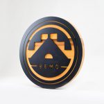 Raised matte black and cedar round exterior sign for BEMO, a Los Angeles based creative studio specializing in VFX, Animation and Immersive Content.