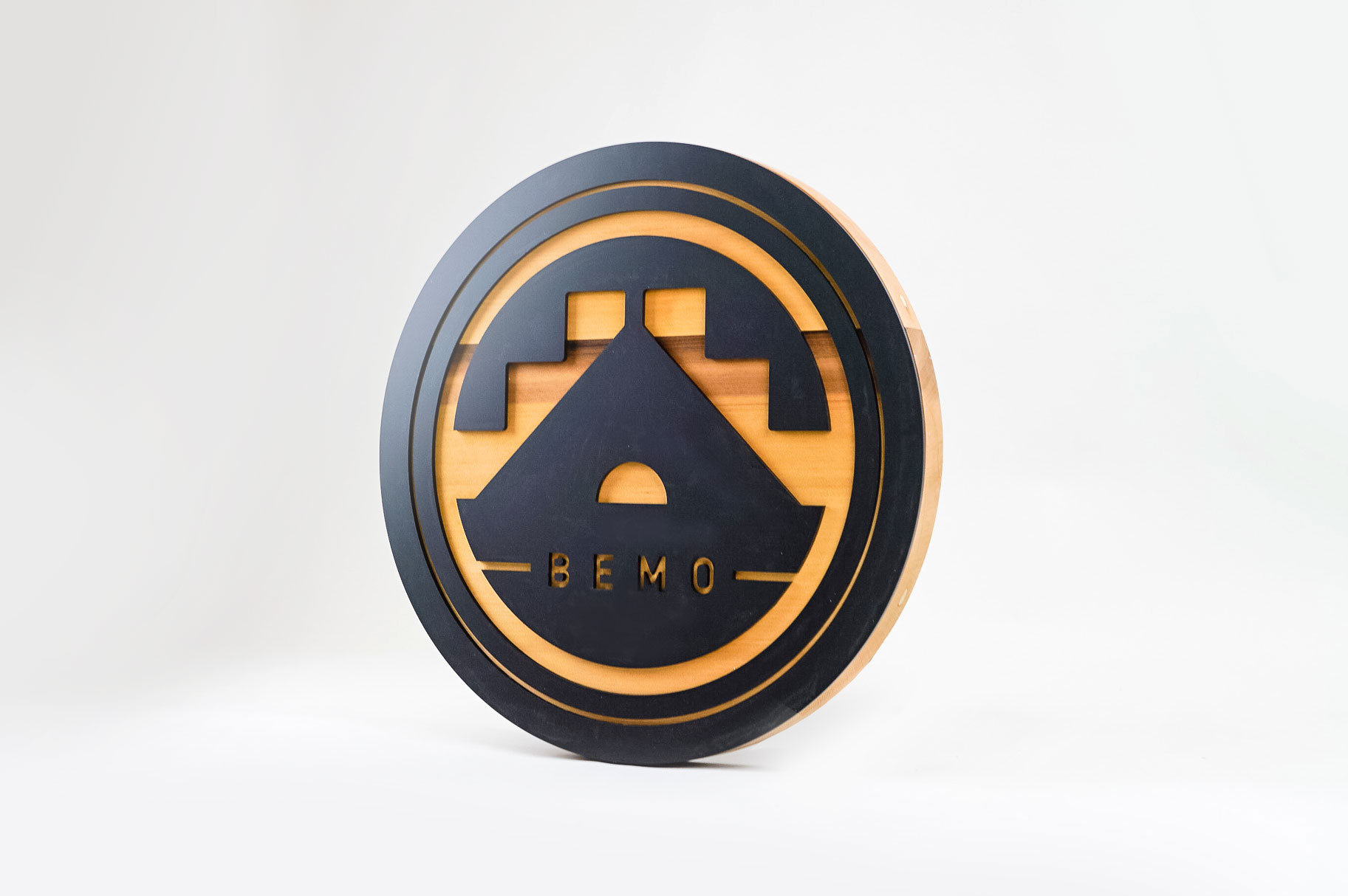 Raised matte black and cedar round exterior sign for BEMO, a Los Angeles based creative studio specializing in VFX, Animation and Immersive Content. Raised matte black and cedar round exterior sign for BEMO, a Los Angeles based creative studio specializing in VFX, Animation and Immersive Content.