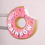 3D, pink-frosted, sculptural, sprinkle donut blade sign for Rainbow Donuts in Berkeley, CA